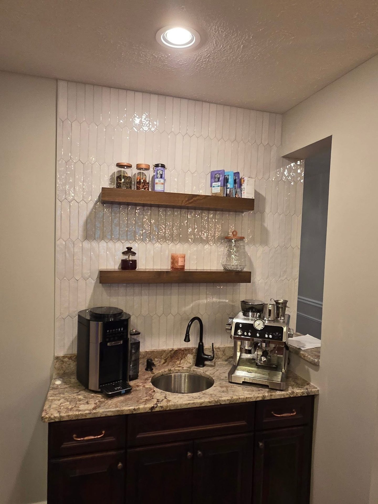 Custom coffee bar with floating shelves and granite top in Grasonville, MD — Assured Contracting Company